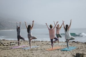 people doing yoga near beach